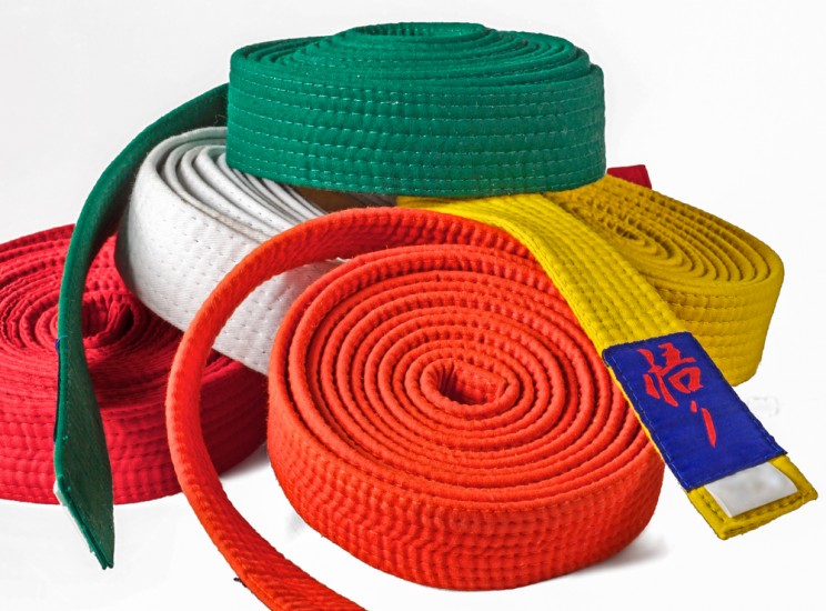 Collection of karate belts piled on top of each other